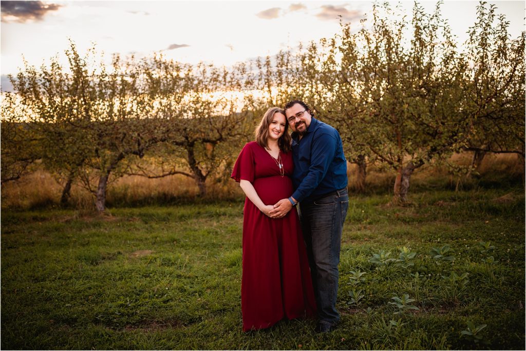 Pregnant couple posed in Rochester, NY Victor Apple farm