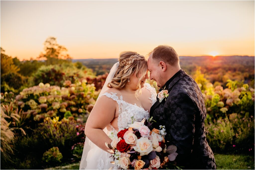 Rochester NY bridal couple embracing each other at Woodcliff Spa during golden hour at sunset with warm florals and landscapes