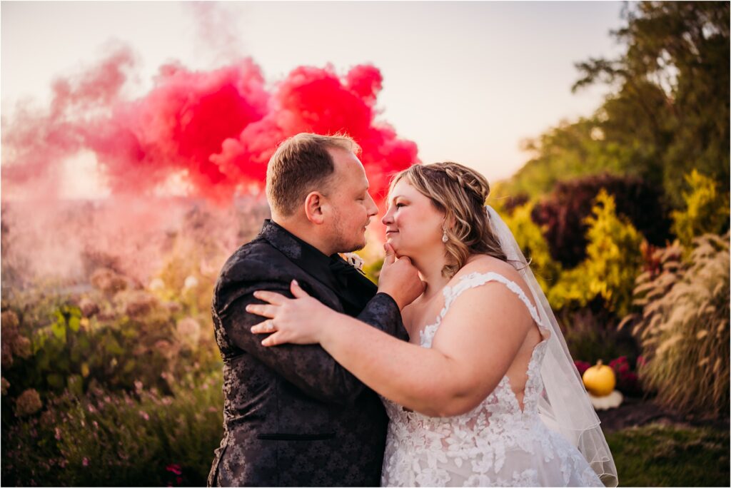 Fun smoke bomb outdoor golden hour wedding portraits full of memorable embracing portraits overlooking all of Rochester NY at Woodcliff Hotel & Spa Venue