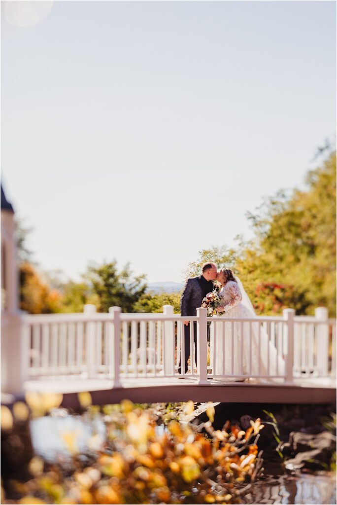 Rochester NY bridal couple embracing each other at Woodcliff Hotel & Spa during golden hour at sunset with warm florals and landscapes